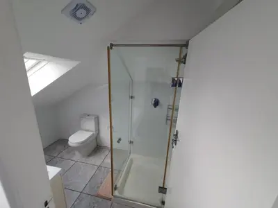 a bathroom with a shower and a toilet at Woodbridge Lodge in Cape Town