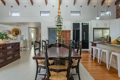 a kitchen with a wooden table and a dining room at Swallows Summer Home in Paarl