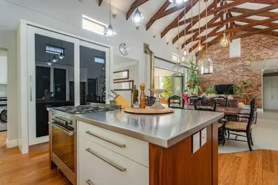 a kitchen with a counter top and a stove top oven at Swallows Summer Home in Paarl