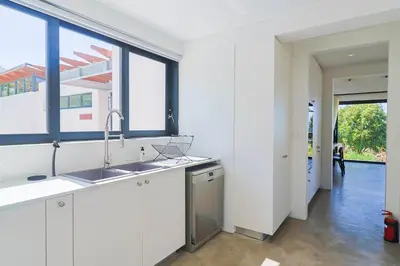 a kitchen with a sink and a large window at BonAir Betty's Bay in Bettyʼs Bay