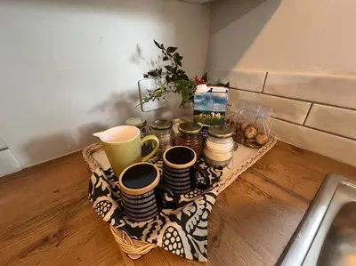 a tray of cups and plates on a table at #Spacious Cozy Stay- Free parking in Stellenbosch