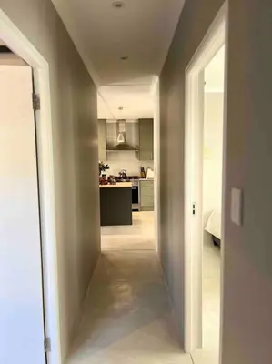 an open hallway leading to a kitchen in a house at Amazing Brand New Holiday Home with Pool! in Hermanus