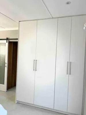 a large white cabinet in a room at Amazing Brand New Holiday Home with Pool! in Hermanus