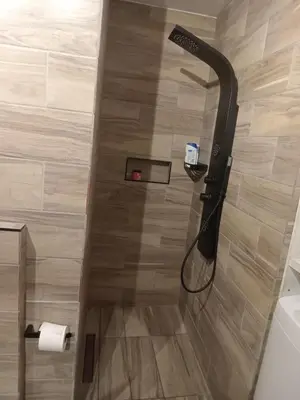 a shower with a shower head in a bathroom at Sea View Serenity on Strand in Cape Town