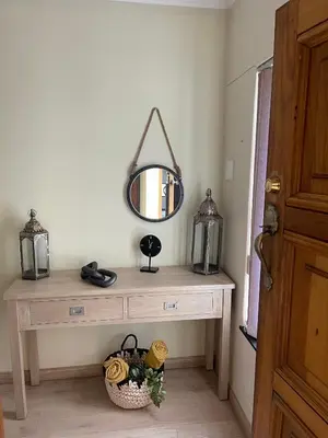 a dressing table with a mirror on top of it at Sea View Serenity on Strand in Cape Town