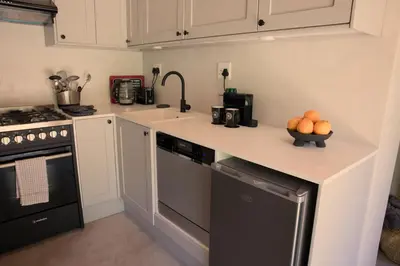 a kitchen with a counter with a bowl of oranges on it at Fynbos Cottage with Sea View - Self-catering in Bettyʼs Bay