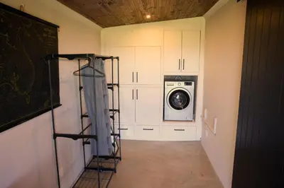 a laundry room with a washer and dryer at Fynbos Cottage with Sea View - Self-catering in Bettyʼs Bay
