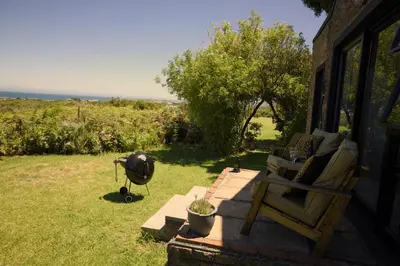 a grill sitting on the side of a house at Fynbos Cottage with Sea View - Self-catering in Bettyʼs Bay