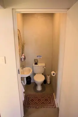 a bathroom with a toilet and a sink at Cozy House with Sea and Mountain Views in Bettyʼs Bay