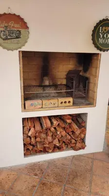 a pile of fire wood in a toy oven at Super Cosy Cottage in quiet area VanzylsRus in Cape Town
