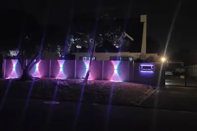 a wall with pink and blue lights on it at Super Cosy Cottage in quiet area VanzylsRus in Cape Town