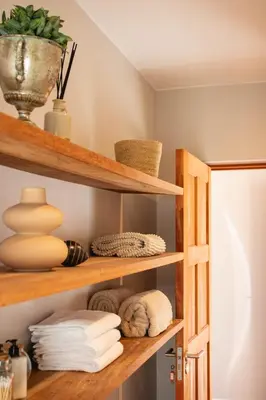 a room with wooden shelves with towels at Bikini House - With Pool in Hermanus