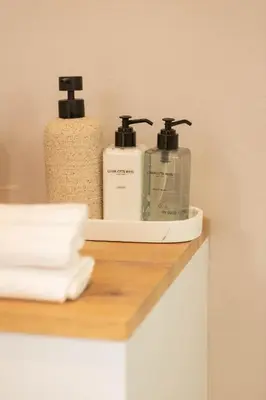 two bottles ofodorizers sitting on a shelf in a bathroom at Bikini House - With Pool in Hermanus