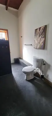 a bathroom with a white toilet in a room at Villa Villiers in Villiersdorp