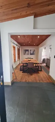 a large dining room with a wooden table in a room at Villa Villiers in Villiersdorp