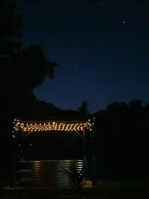 a pergola with lights on it at night at Villa Villiers in Villiersdorp