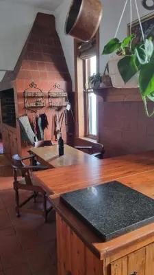 a kitchen with a wooden counter and a table at Château Naudé in Stellenbosch Free Secure Parking in Stellenbosch