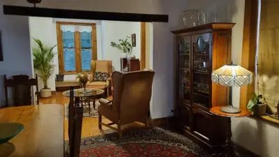 a living room with a chair and a table at Château Naudé in Stellenbosch Free Secure Parking in Stellenbosch