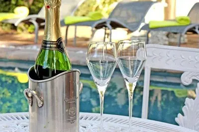two champagne glasses in an ice bucket on a table at Somerset Garden Route Apartments & Wellness in Somerset West