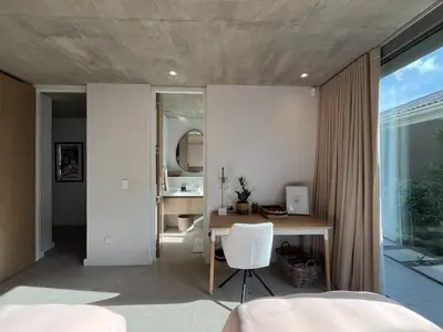 a bedroom with a desk and a table with a chair at The Hermanus Retreat in Hermanus