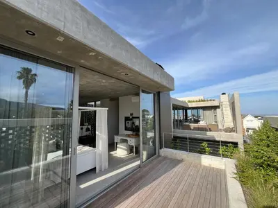 an open balcony with a view of the city at The Hermanus Retreat in Hermanus