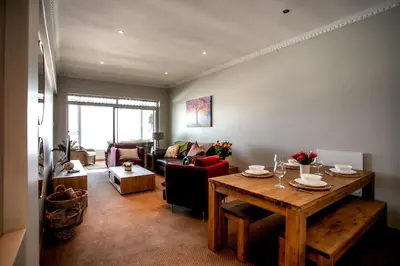 a living room with a table and a couch at Bayview 307 in Hermanus