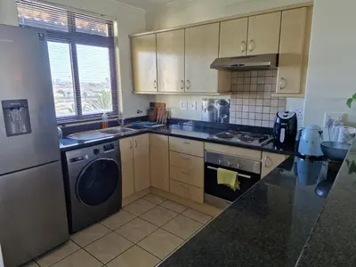 a kitchen with a washer and a dishwasher at Island Club apartment in Century City - 305 Ibiza in Cape Town