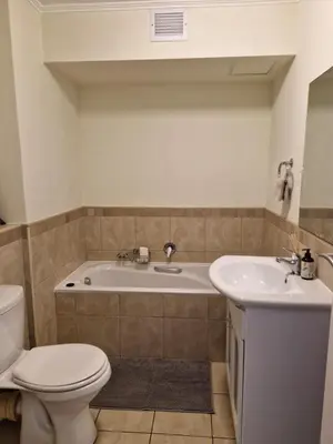 a bathroom with a tub and a toilet and a sink at Island Club apartment in Century City - 305 Ibiza in Cape Town