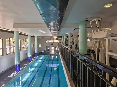 a large indoor swimming pool with a bridge at Island Club apartment in Century City - 305 Ibiza in Cape Town
