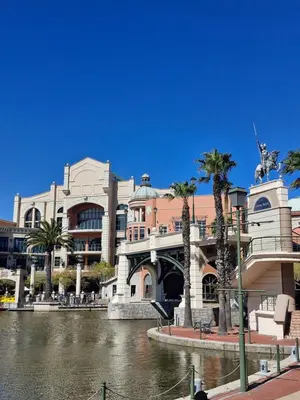 a large building next to a river with palm trees at Island Club apartment in Century City - 305 Ibiza in Cape Town