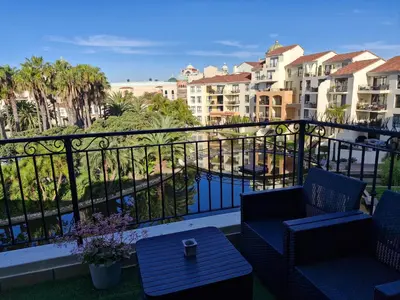 a balcony with chairs and a view of a building at Island Club apartment in Century City - 305 Ibiza in Cape Town