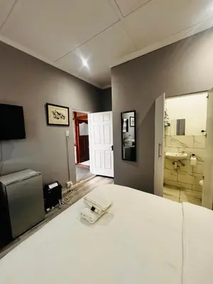a room with a bed with a phone on it at Mila Lodge 2 in Goodwood