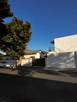 a car parked in a parking lot next to a house at Mila Lodge 2 in Goodwood