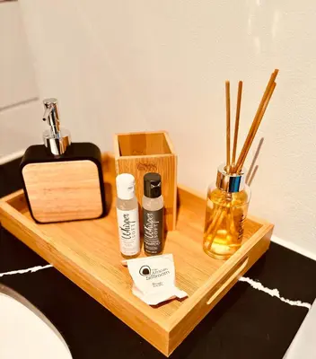 a wooden table with two bottles and a box at ZALS Luxury Accommodation-One bed-Cape Town in Cape Town