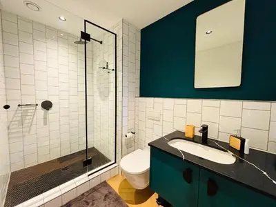 a bathroom with a toilet and a sink and a shower at ZALS Luxury Accommodation-One bed-Cape Town in Cape Town