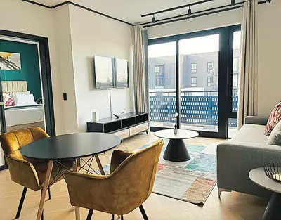 a living room with a couch and a table and chairs at ZALS Luxury Accommodation-One bed-Cape Town in Cape Town