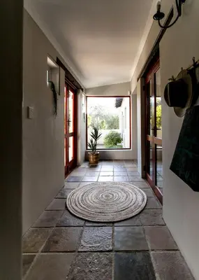 a hallway with a rug on the floor at Plaisir du Cap in Hermanus