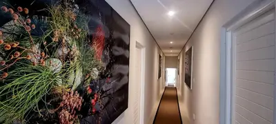 a hallway with a large painting on the wall at C'est la Vie 3 in Franschhoek