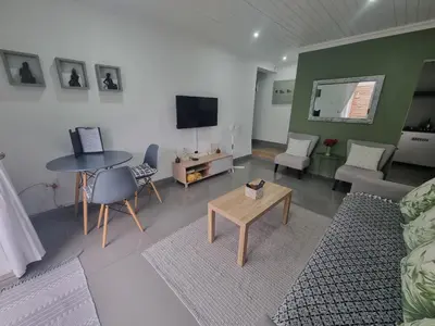 a living room with a couch and a table at 1 On Sonnet Unit Mia in Cape Town