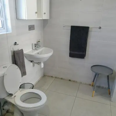a bathroom with a toilet and a sink at 1 On Sonnet Unit Mia in Cape Town