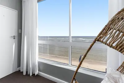 a room with a window with a view of the beach at Odeon Towers 1102 in Cape Town
