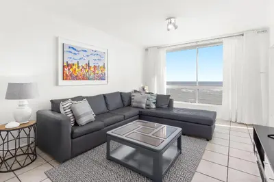 a living room with a couch and a table at Odeon Towers 1102 in Cape Town