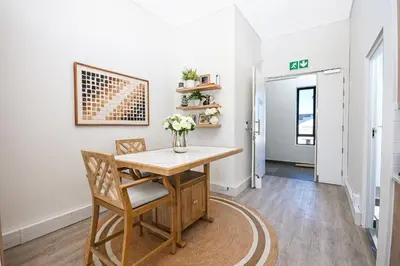 a dining room with a table and chairs at 308 on Titanium in Strand