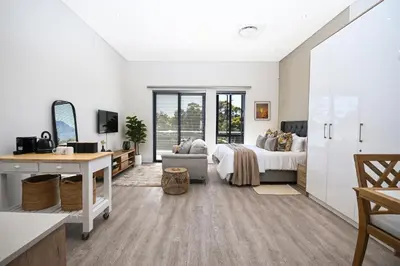 a bedroom with a bed and a desk at 308 on Titanium in Strand