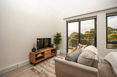 a living room with a couch and a flat screen tv at 308 on Titanium in Strand
