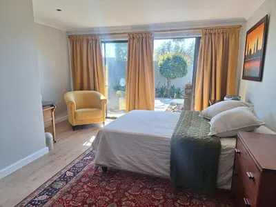 a bedroom with a bed and a large window at Governor's nest in Cape Town
