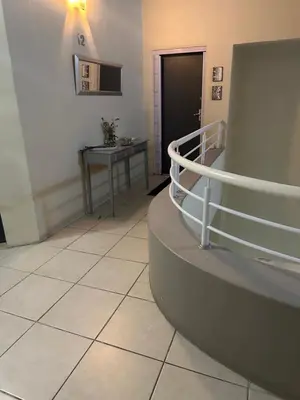 a hallway with a staircase and a table in a room at Clouds in Strand