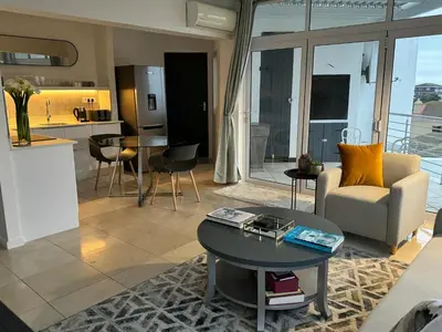 a living room with a couch and a table at Clouds in Strand