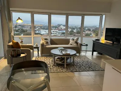 a living room with a couch and a table at Clouds in Strand