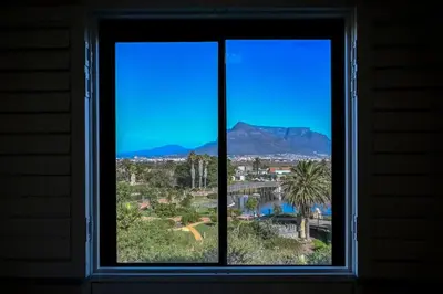 a window with a view of the mountains at BGS Luxury -Two-bed -Nine Palms in Cape Town